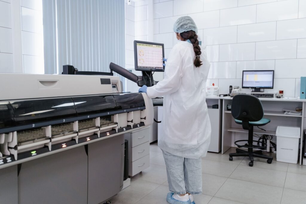 Lab Technician Working With High Tech Equipment In A Medical Laboratory.