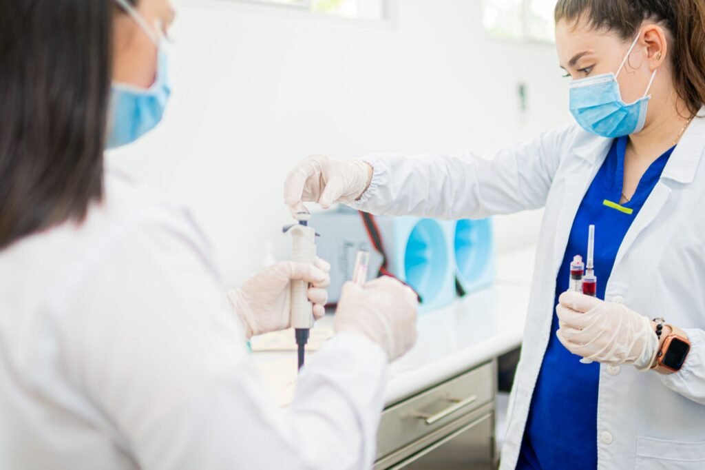 Healthcare Professionals Performing Blood Tests In A Laboratory Setting.