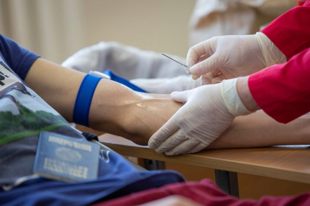Healthcare Professional Drawing Blood From A Patient In A Medical Setting.